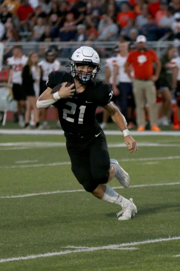 Junior Tristan Baker runs the ball toward the end zone.