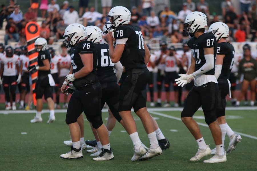 Seniors Jack Melvin, Ty Marsh, junior Gus Hawkins and seniors Will Smoots and  Hayden Jay walk back to their places to begin a play. 