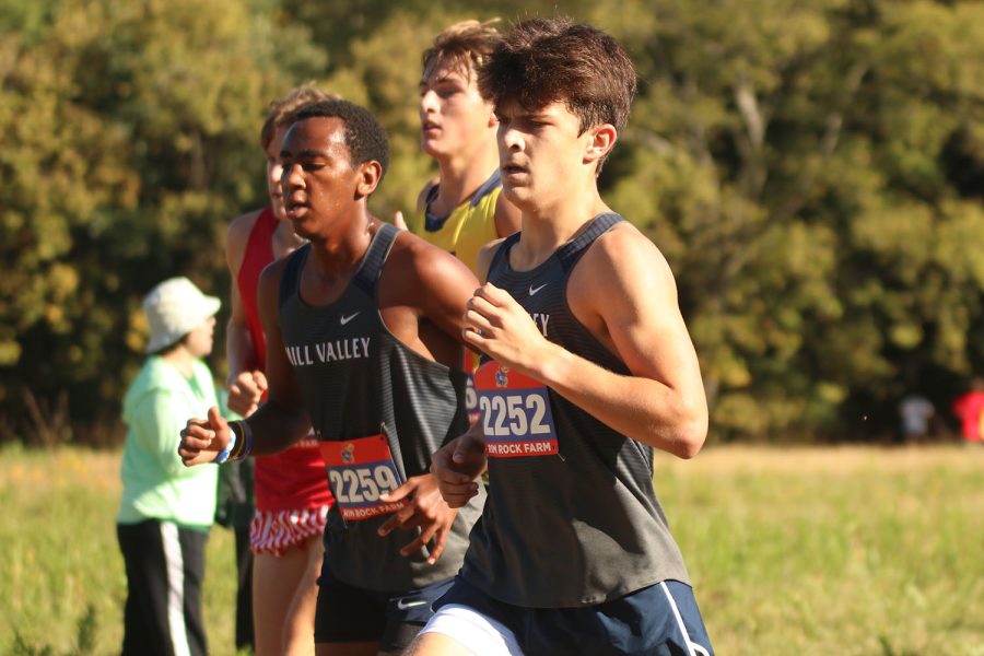 As they round the corner on their first mile, senior Lucas Robins and junior AJ Vega overtake their opponents at the start of the race.