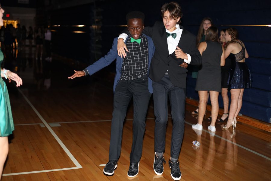 With their arms around each other, sophomores Shawn Njoroge and Hayden Wood dance together. 
