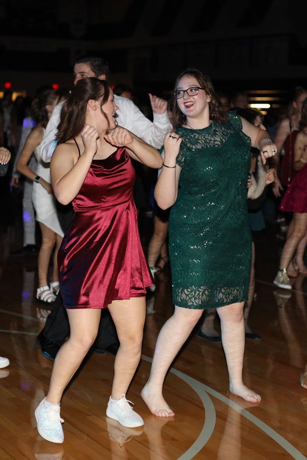 Looking at each other, seniors Kate Hereth and Cassie Frias dance together. 