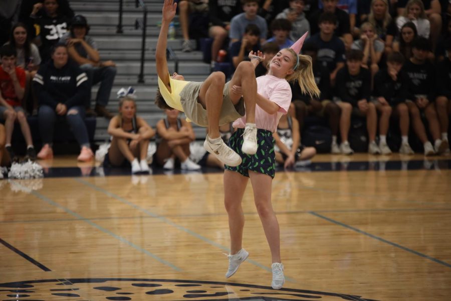 At the end of their dance, senior Homecoming candidate Jenna Myers flips fellow senior Homecoming candidate Eli Olsen. 
