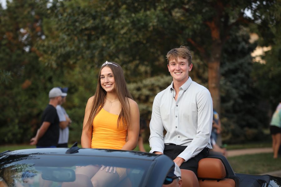 Posing for a picture, senior Homecoming candidates Laney Reishus and Brody Shulda smile at the camera. 