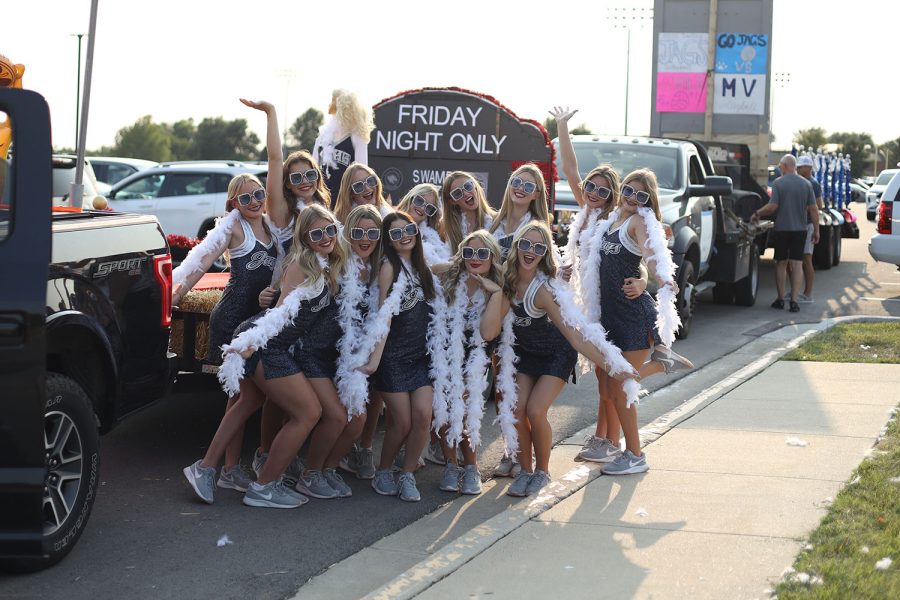 Before the parade, the Silver Stars pose for a picture with their float. 