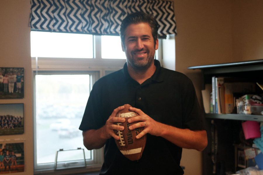 Holding a football Wednesday, Aug. 31, English teacher and football coach Michael Strack is excited to be teaching English again. “I think [Mill Valley] is a great, great place to teach, a great place to coach,” said Strack.