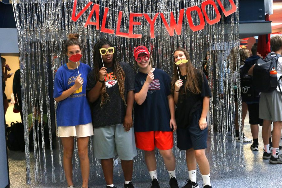 Holding props, a group of juniors show off their Adam Sandler outfits on the first day of Homecoming spirit week.