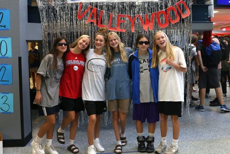 Smiling at the camera, sophomores rock Adam Sandler day with their oversized t-shirts and long shorts.