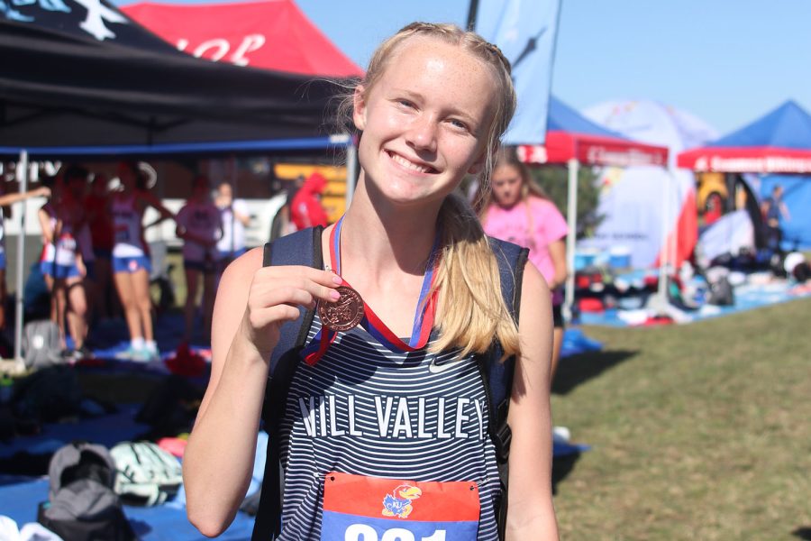 Sophomore Charlotte Caldwell proudly displays her medal for finishing in the top ten at the Rim Rock Classic cross country race. Caldwell faced over one hundred and fifty competitors on the course.
