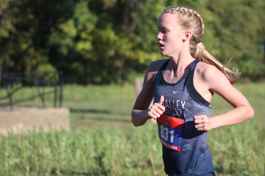 With her head high and her form strong, sophomore Charlotte Caldwell completes her first mile while maintaining her second place position out of 150 runners. 