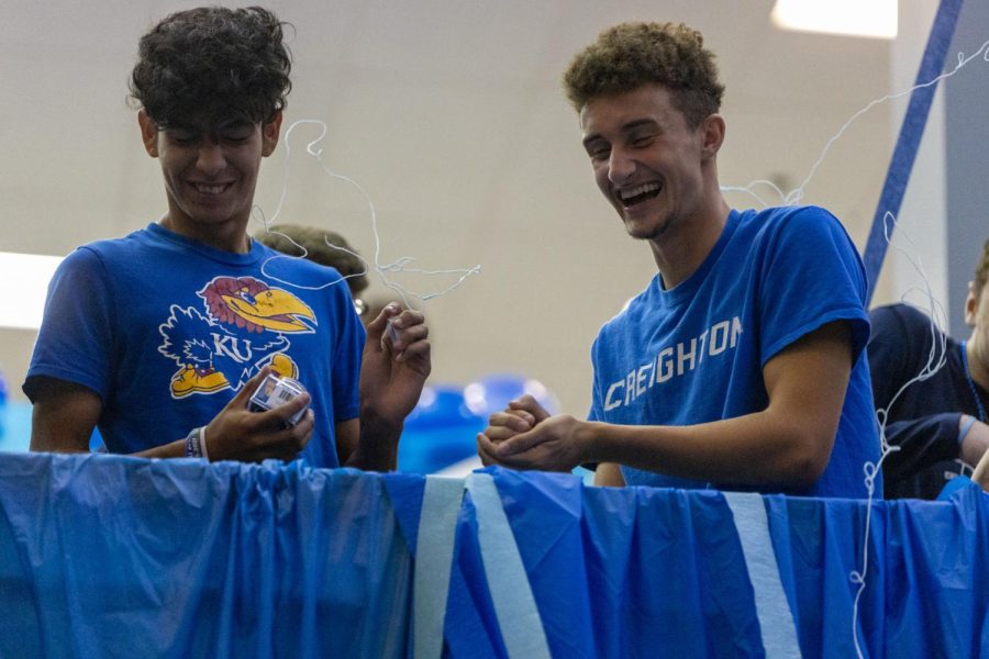 Being sprayed with blue silly string, seniors Dylan Ashford and Diego Martin smile at the chaos. 
