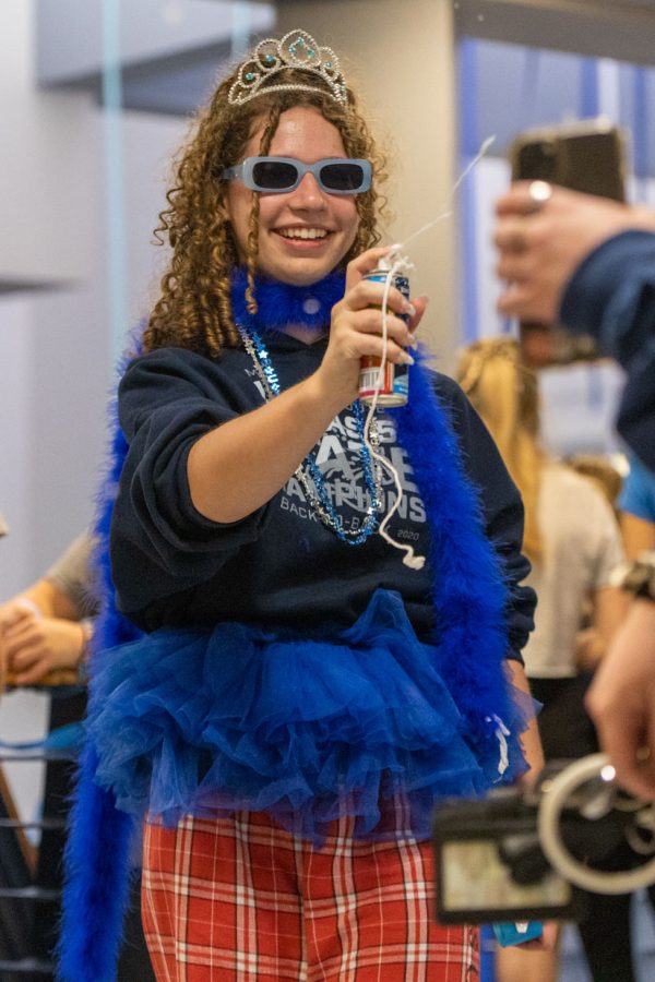 Spraying silly string at her friend, senior Maya Parks smiles. 