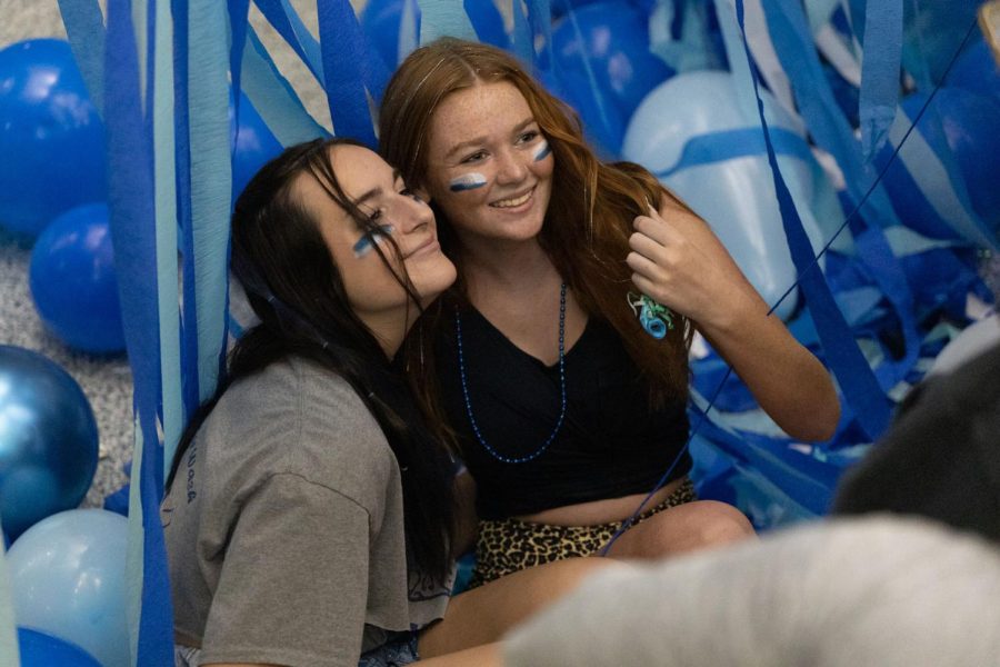  Sitting in the middle of the mosh pit, seniors Kate Hendrix and Izzy Sommerfeld pose for a picture. 
