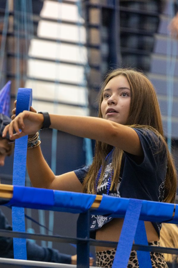 Preparing to throw, senior Eden Hakes aims the blue streamer at her target in front of her. 
