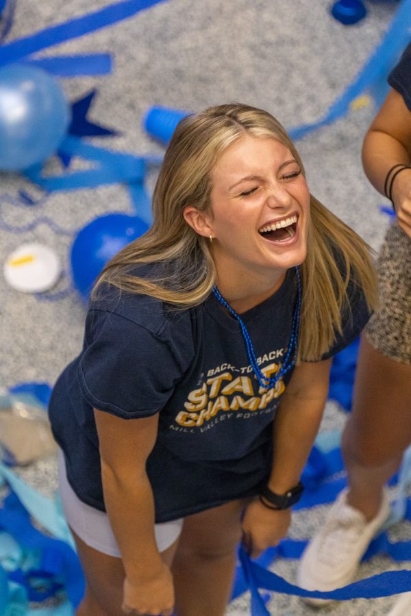 In the middle of the foyer, senior Dylan Dedrickson laughs at the mess around her. 
