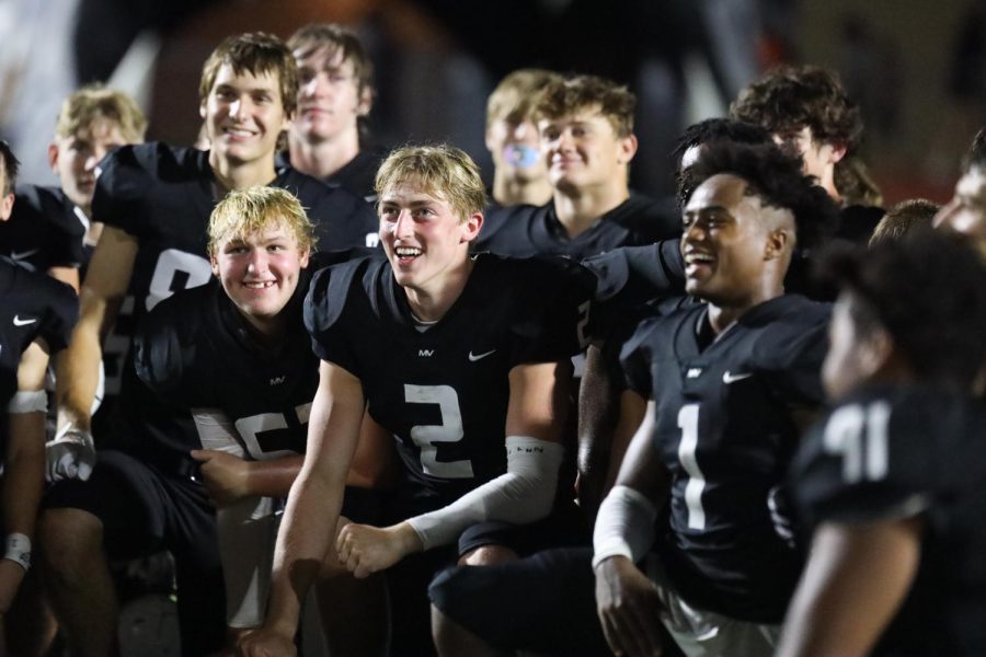 In the huddle alongside his teammates, senior Hayden Jay laughs at his coaches jokes. 

