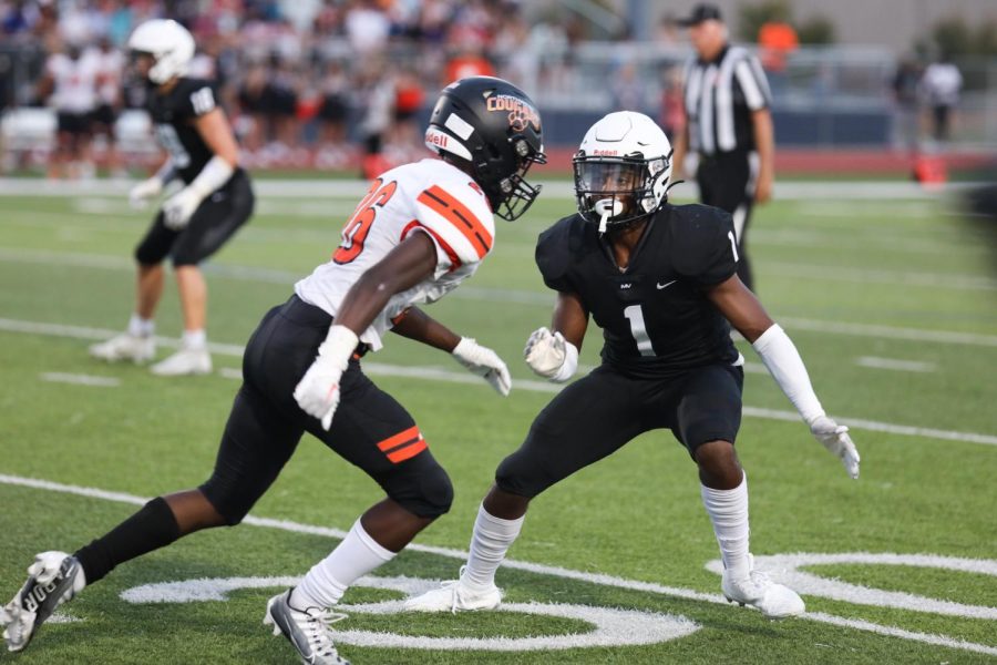 Covering his man, senior defensive back Baruch Hasabu gets ready to run. 
