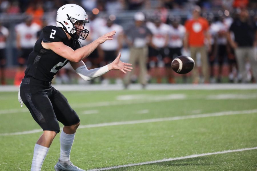 Ready to start the play, senior quarterback Hayden Jay holds his hands out for the ball.
