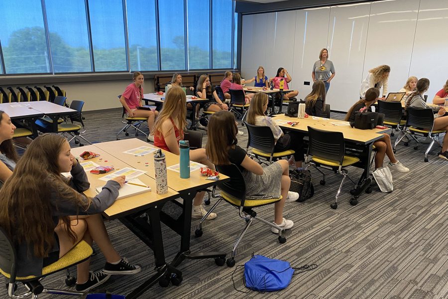 Gathering in a room, students get ready for the middle school workshop.