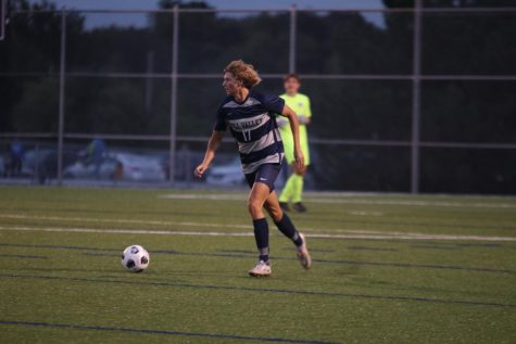 Senior Nicholas Hodson brings the ball back up the field after stopping an attack.