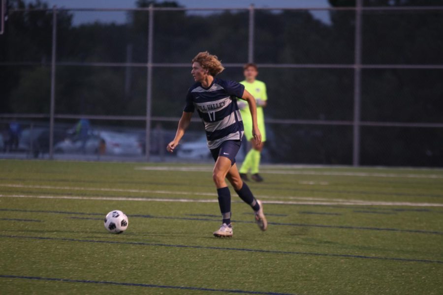 Senior Nicholas Hodson brings the ball back up the field after stopping an attack.