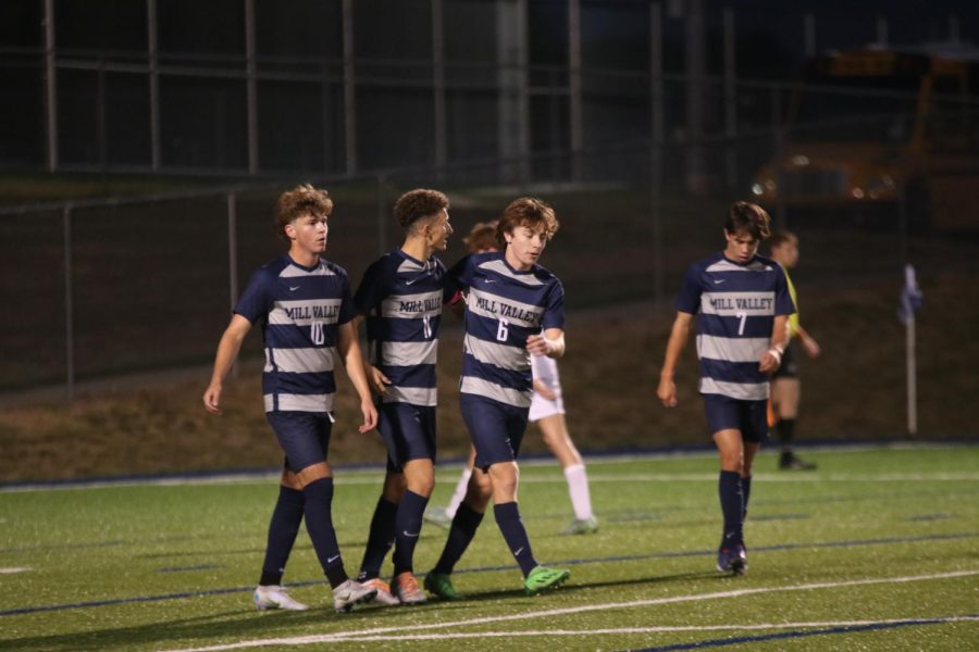 Celebrating a goal, seniors Nico Pendleton, Dylan Ashford and Toby Kornis make their way back to midfield.