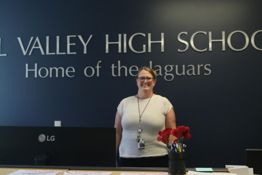 Standing behind her desk, office secretary Julie Rugenstein is eager to work alongside her fellow office staffers at Mill Valley 