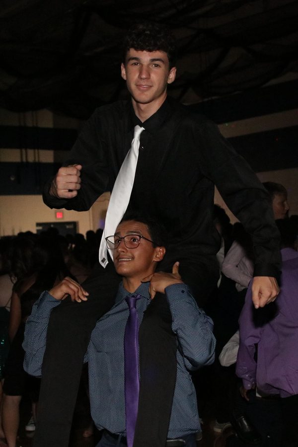 On top of junior Lucian Zaragoza, sophomore Zach Casper dances to the beat.