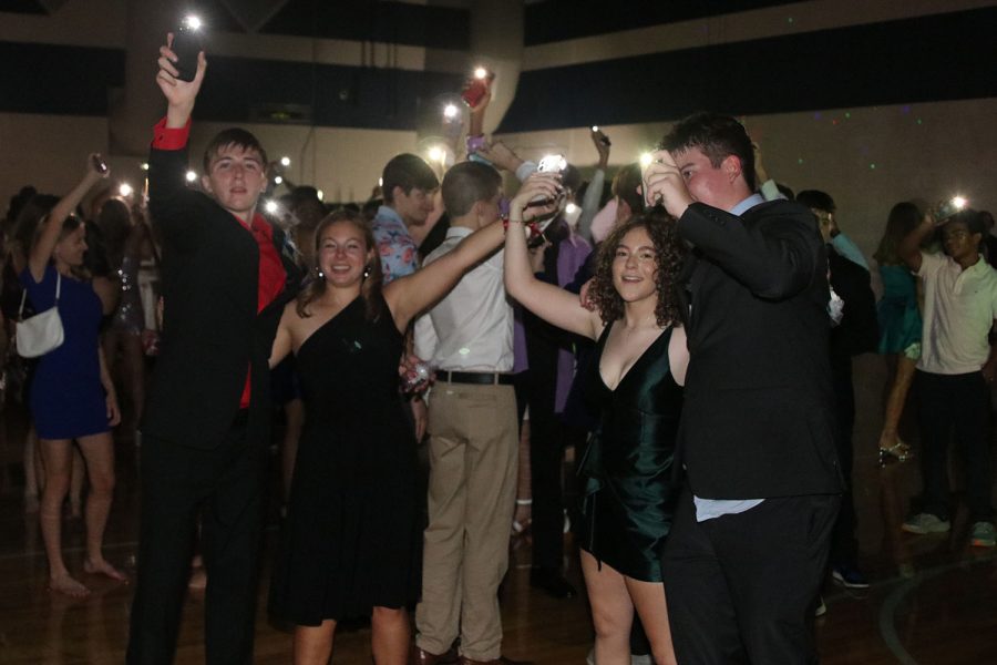 To “Sweet Caroline,” juniors Sebastian Smith, Mackenzie Simpson, Katie Fredericks and Luke Wilson all flash their phone flights to set the mood.