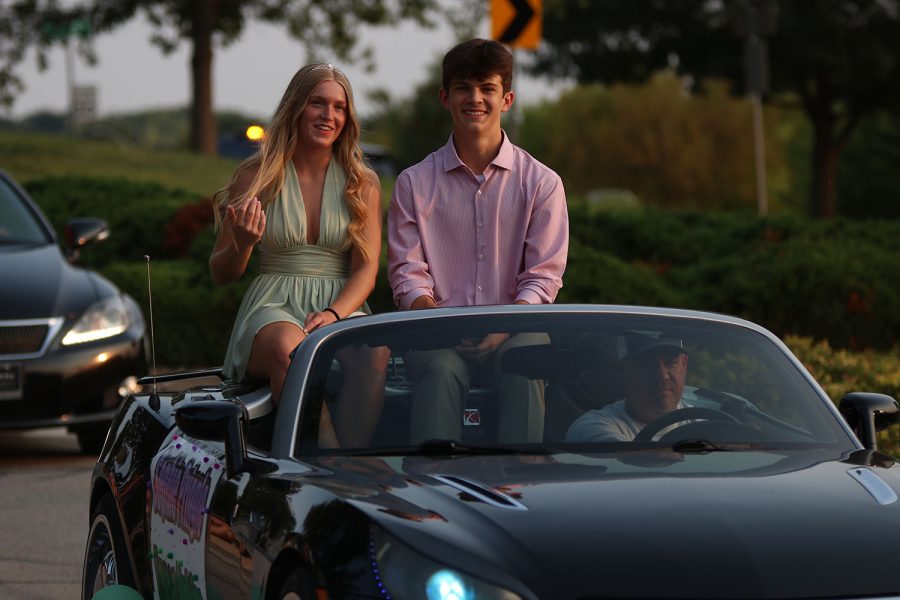 Sitting atop their decorated float, senior Homecoming candidates Sophie Pringle and Lucas Robins, smile at the crowd.