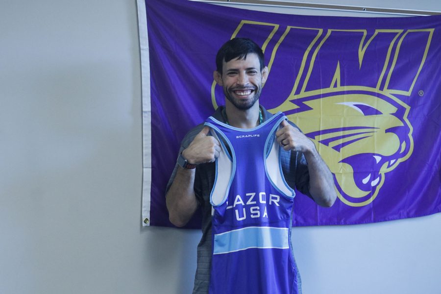 Holding up his Olympic wrestling singlet Wednesday, Aug. 31, math teacher and head wrestling coach Joey Lazor is excited to be a part of the community at Mill Valley after coming from teaching at a Catholic school. 