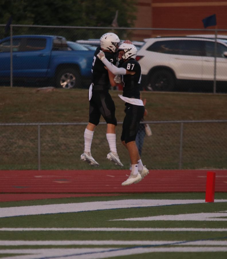 Senior Hayden Jay and his teammate, senior Will Smoots, jump in excitement after scoring a touchdown.