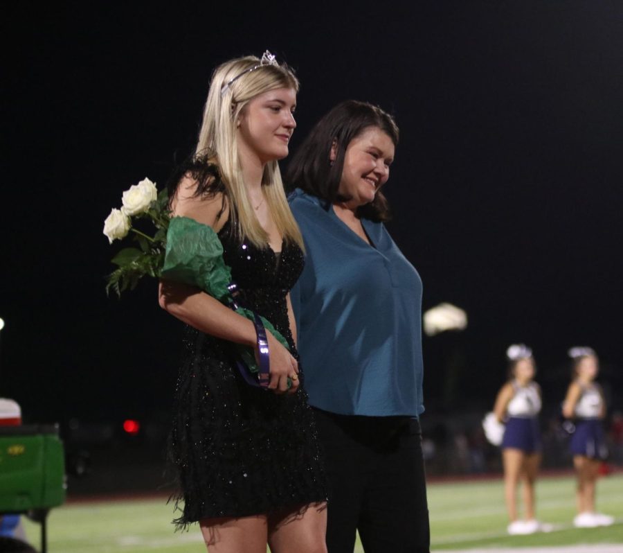 Senior Homecoming candidate Jenna Myres sharing a loving mother daughter moment as she walks in the Homecoming coronation ceremony.