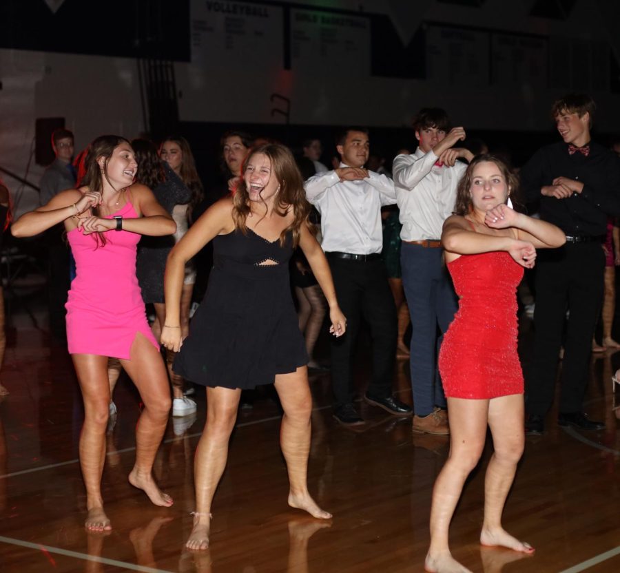 Juniors Ellie Walker, Lucy Roy and Kynley Verdict laugh as they dance together.

