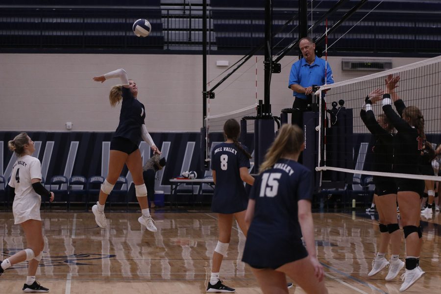 Showing off her vertical, senior Madeline Schnepf hits the ball over the net. The volleyball team faced Olathe South and Shawnee Mission North on Tuesday, Sept. 20, where they defeated both teams in two sets.
