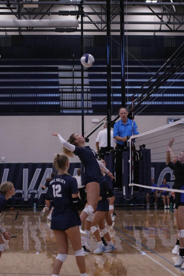 Eyes on the ball, senior Madeline Schnepf hits the ball over the net. 