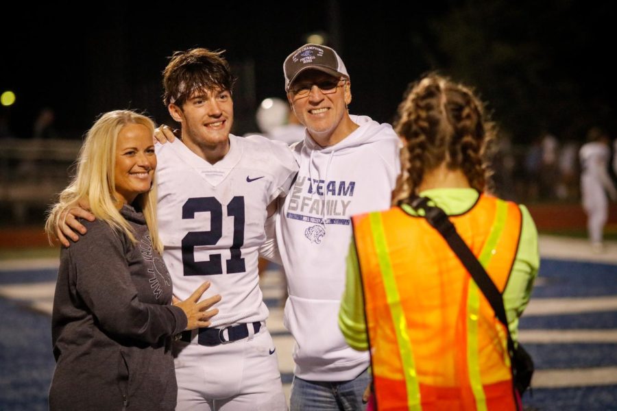 Junior Tristan Baker and his family pose for a picture to commemorate them on Sept. 23