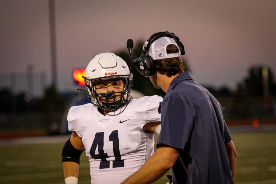 Junior Ryan Deverill and coach Reece Petty talk about the previous play.