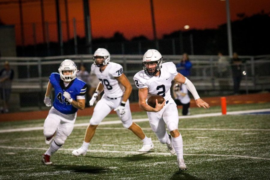 Quarterback senior Hayden Jay dodges a Gardner-Edgerton lineman in an effort to make a first down.