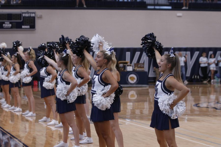 Juniors Madeline Epperson and Claire Moberly perform to the fight song as students fill the gym for the Homecoming assembly. 
