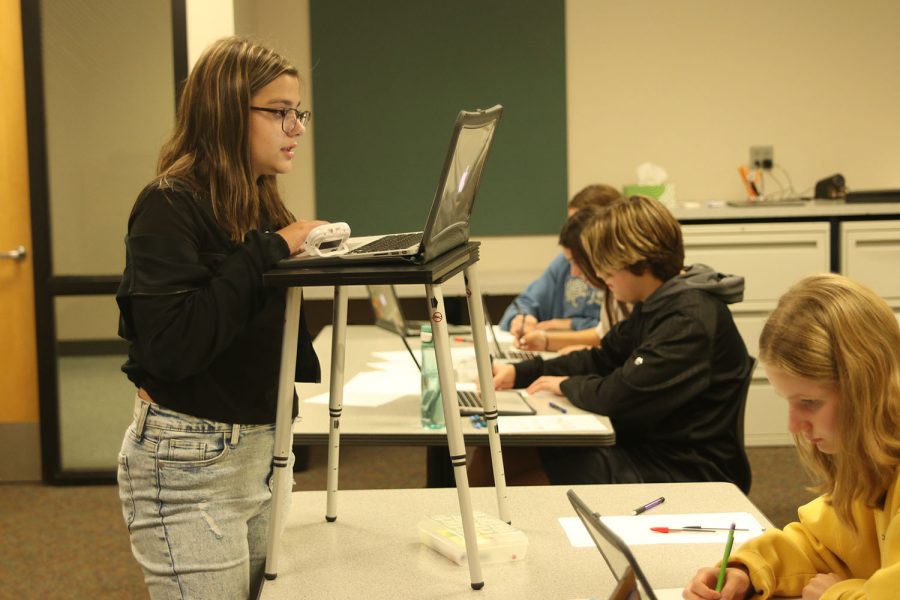 Presenting her argument about vaccine policy, freshman Callyn Ambrose stands in front of her teammates for a practice round Friday, Sept 23. 

