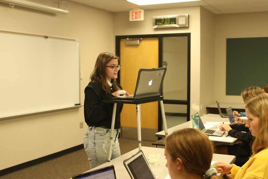 During the first eight-minute speech, freshman Callyn Ambrose outlines the argument while her teammates follow along Friday, Sept 23. 