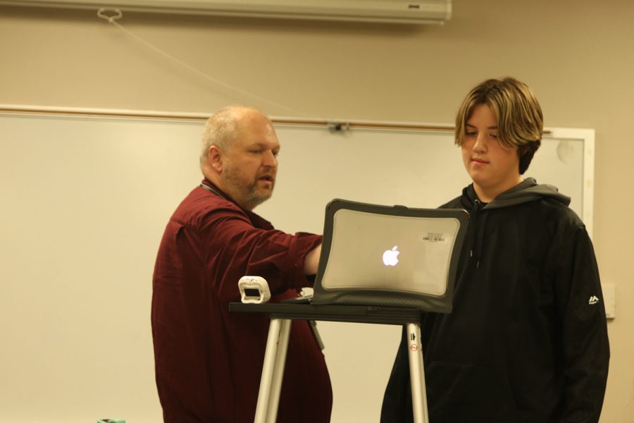 Pointing to the computer, debate and forensics teacher Shawn Rafferty gives freshman Barron Fox advice on what to say Friday, Sept 23. 
