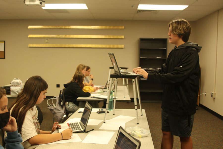 Reading the affirmative speech for the debate team’s second practice round, freshman Barron Fox stands at the front of the room Friday, Sept 23. 

