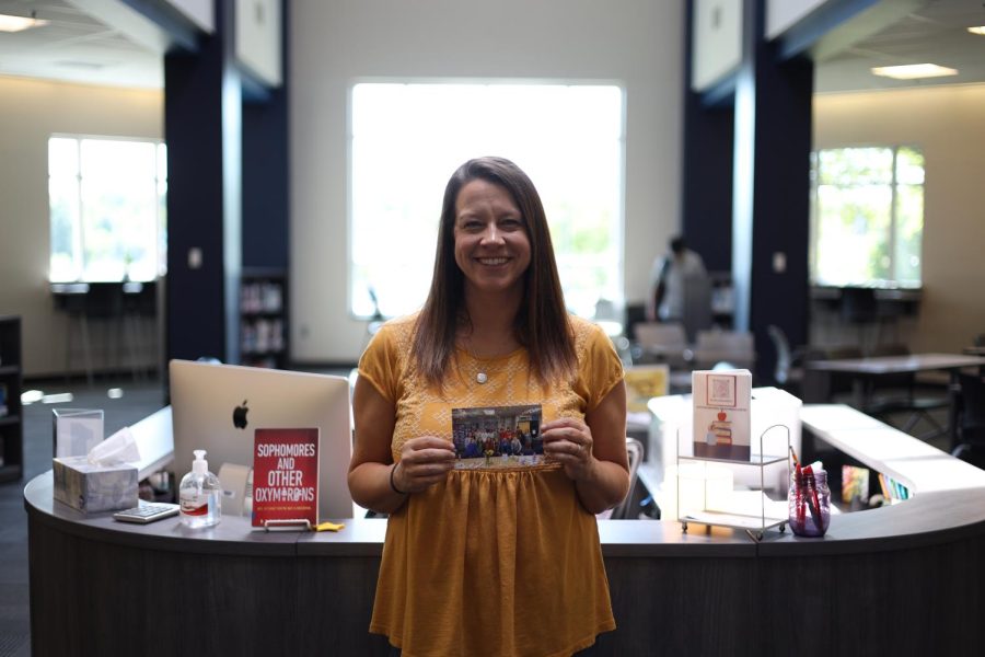 Holding a picture of her seminar from last year, Media Specialist Ashley Agre reminisces on her time with her class saying, Leaving them was a very hard thing, so I have our picture from our group last year where I can see it every day.