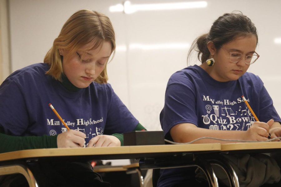 Junior Emma Clement and freshman Quinlyn Peters work on the math section.