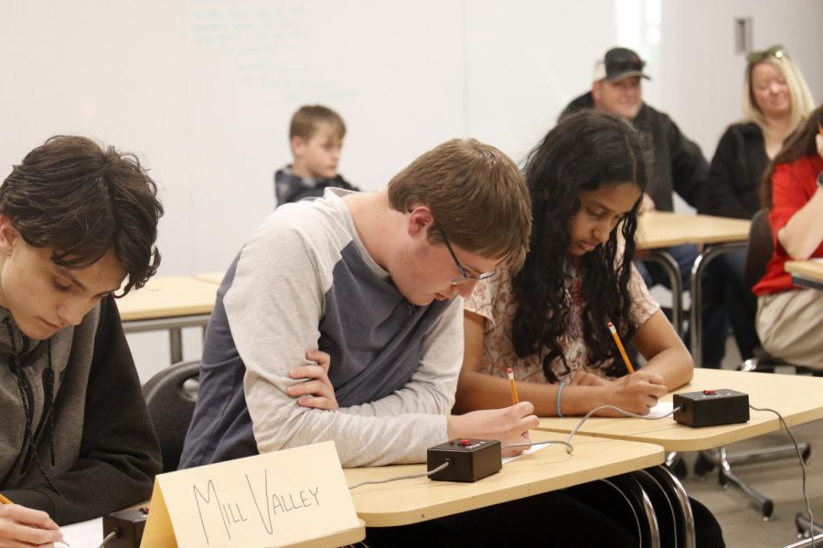 Focused on the problem, senior Jackson Wilhoit and freshmen Ian Weatherman and Rachel Joseph brainstorm.