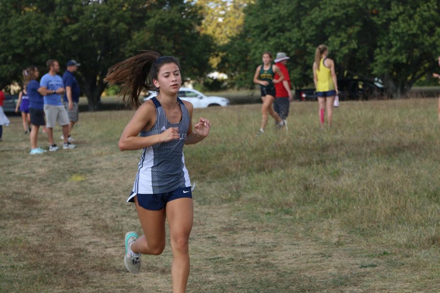Around a curve, sophomore Isabel Cherrito keeps a steady pace.