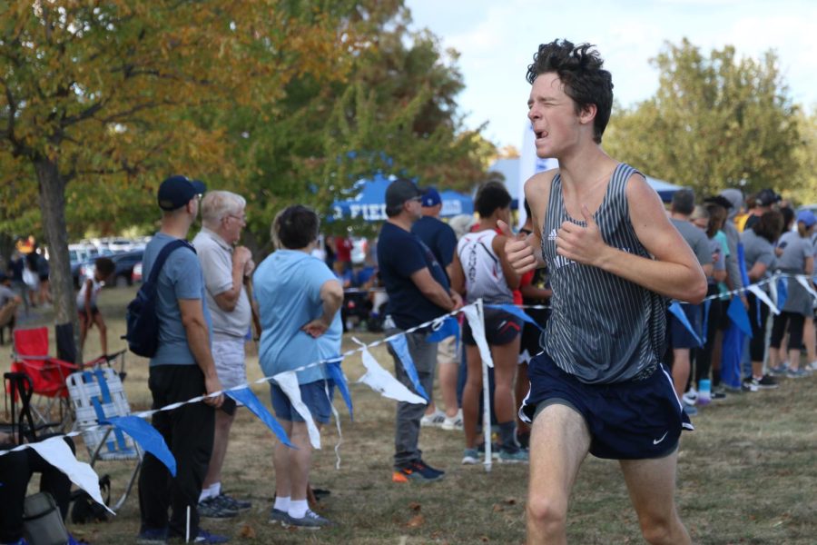 Pushing to get across the finish line, junior Brett Stockwell runs.