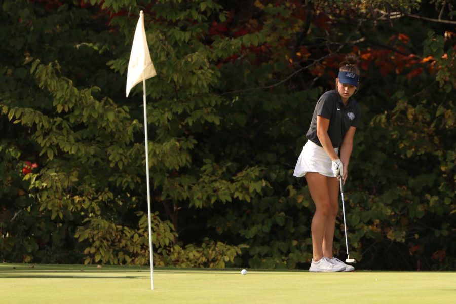 Freshman Lola Dumler watches as her ball rolls toward hole number 2. 
