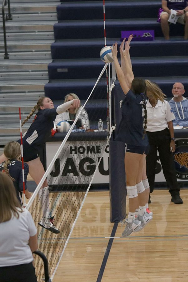 Blocking the ball, sophomore Ashlyn Blazer stops it from going over the net. 